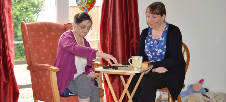 Genesis residential home playing dominoes